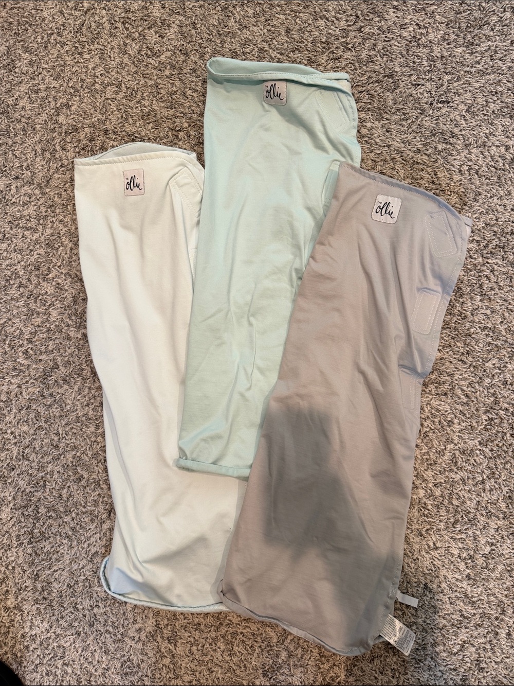The Ollie Swaddle in Mint, Light Gray, and Light Blue